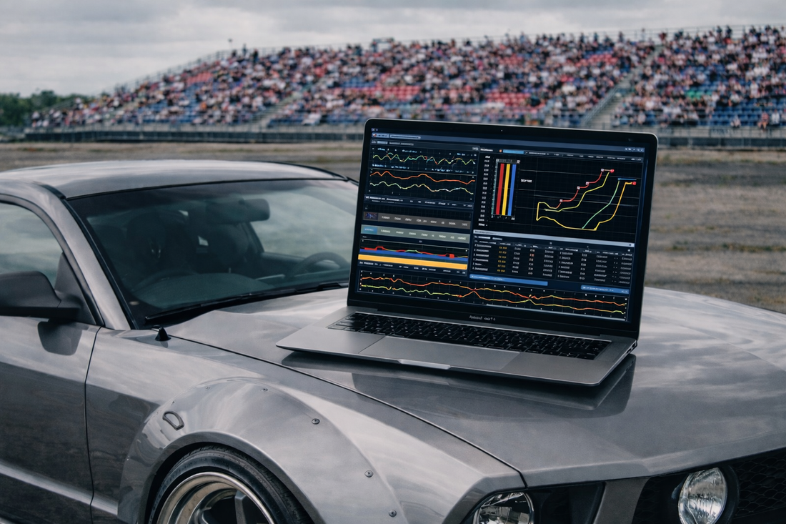 Drift telemetry and drift car data analysis displayed on a MacBook Air at a grassroots drifting event